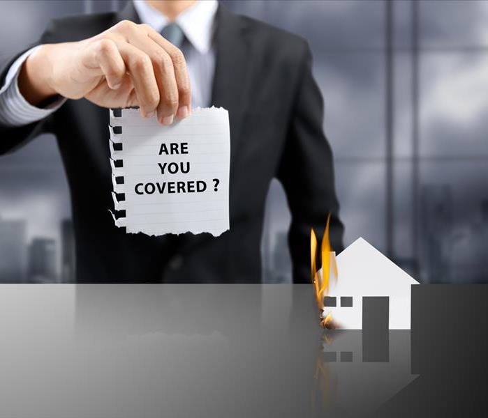 businessman present insurance concept with burning house